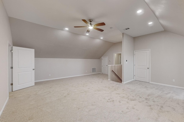 additional living space with ceiling fan, light colored carpet, and lofted ceiling