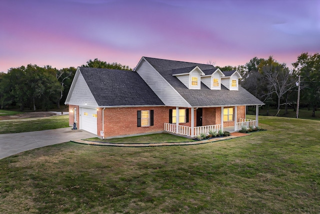 cape cod home with a porch, a garage, and a yard