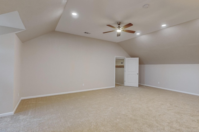 additional living space featuring light carpet, vaulted ceiling, and ceiling fan