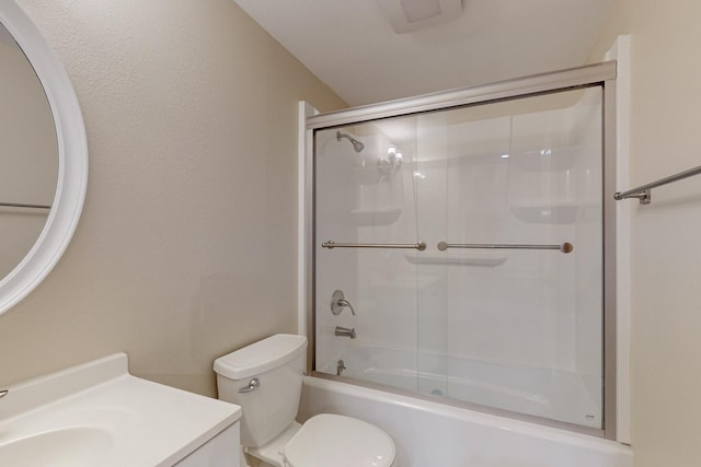 full bathroom featuring vanity, shower / bath combination with glass door, and toilet