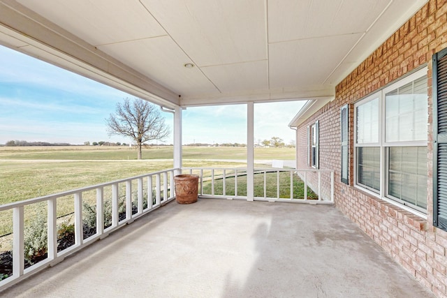 view of patio featuring a porch and a rural view