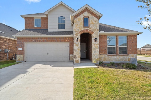 view of front of property featuring a front yard and a garage