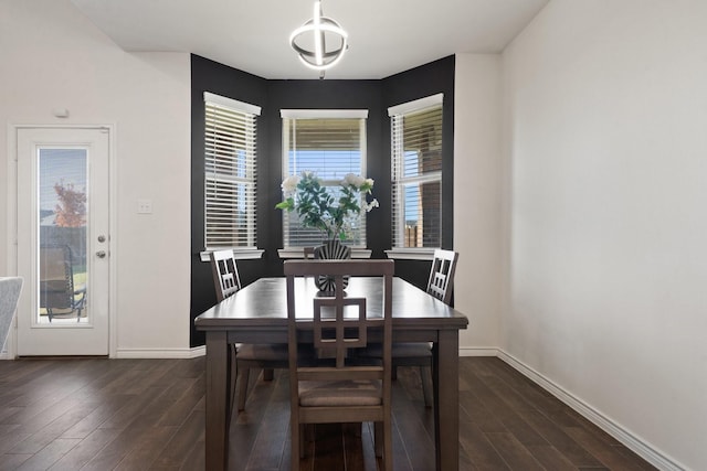 dining space with dark hardwood / wood-style flooring