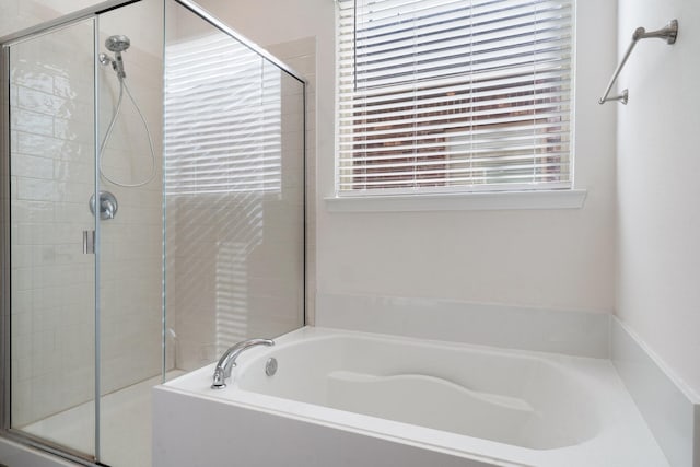 bathroom featuring separate shower and tub