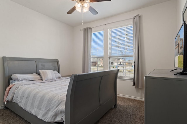 carpeted bedroom featuring multiple windows and ceiling fan