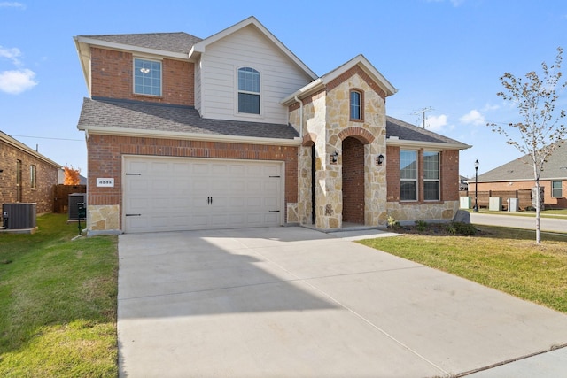 view of front of house featuring central AC, a garage, and a front lawn