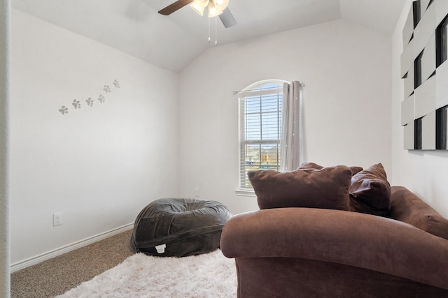 sitting room with ceiling fan, lofted ceiling, and carpet floors