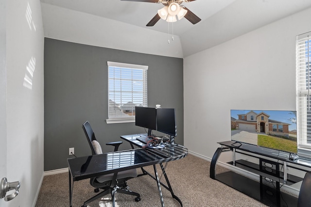 carpeted home office featuring vaulted ceiling, ceiling fan, and a healthy amount of sunlight