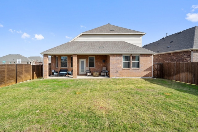 back of house featuring an outdoor hangout area, a patio area, and a lawn