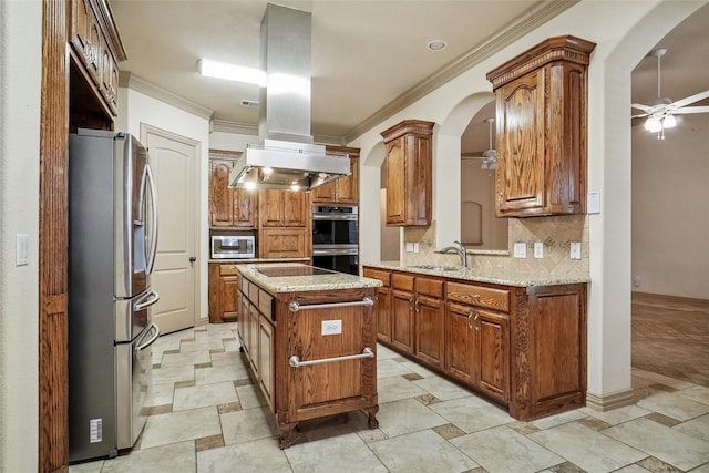 kitchen with sink, island range hood, a kitchen island, ceiling fan, and stainless steel appliances