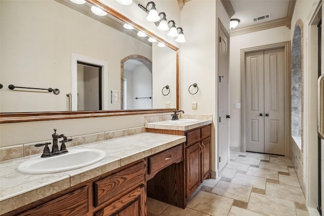 bathroom featuring crown molding and vanity