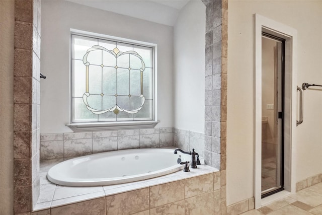 bathroom featuring shower with separate bathtub