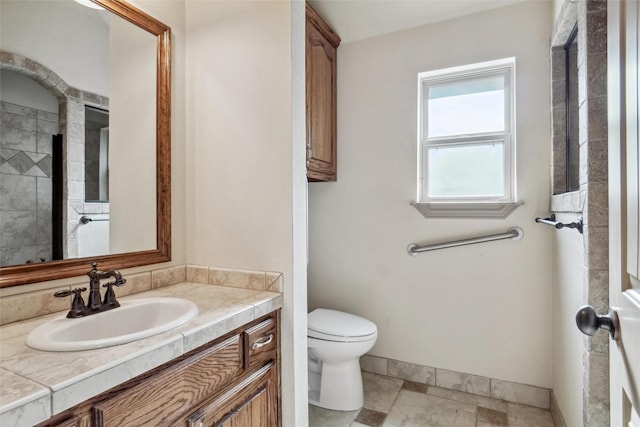 bathroom featuring tile patterned flooring, vanity, and toilet