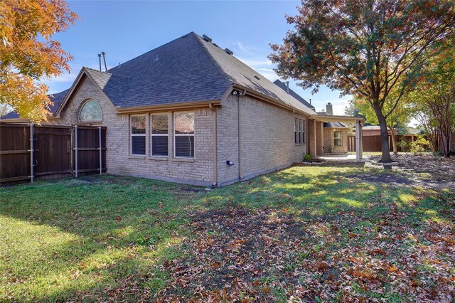 rear view of house with a yard