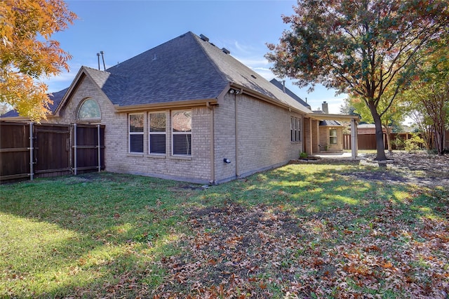 rear view of property featuring a yard