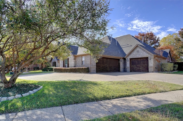 view of front of home featuring a garage and a front lawn