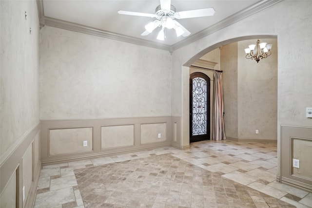 foyer entrance featuring ceiling fan with notable chandelier and crown molding