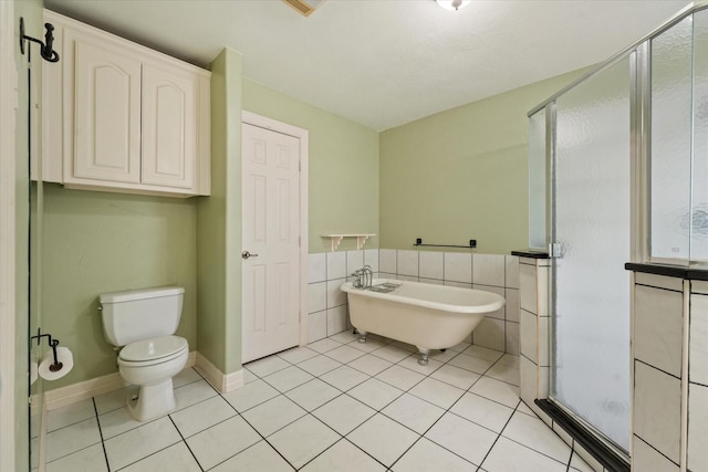 bathroom with toilet, independent shower and bath, tile patterned flooring, and tile walls