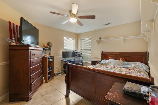 bedroom with ceiling fan and light tile patterned floors