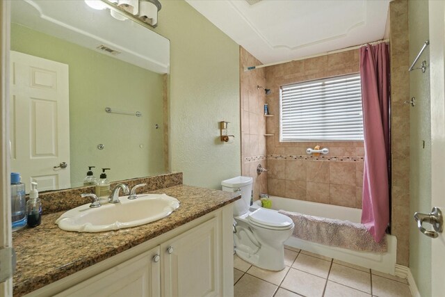 full bathroom featuring tile patterned flooring, vanity, shower / tub combo with curtain, and toilet