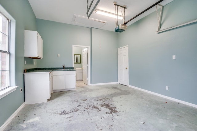 garage featuring sink and a garage door opener