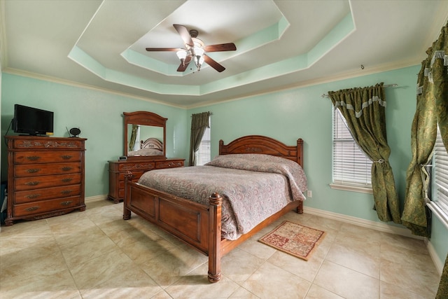 tiled bedroom featuring ceiling fan, a raised ceiling, and ornamental molding