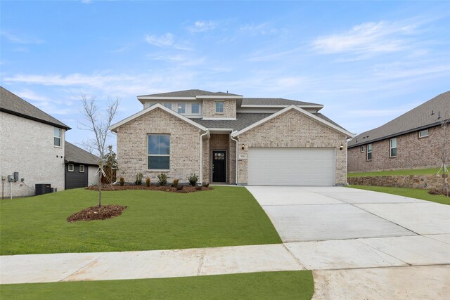 view of front of house with a garage and a front yard