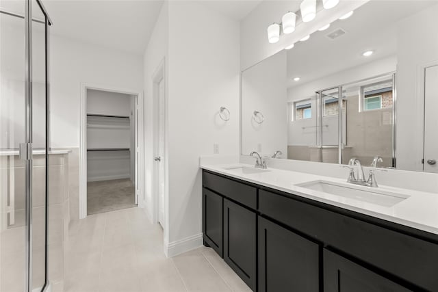 bathroom with tile patterned floors, an enclosed shower, and vanity