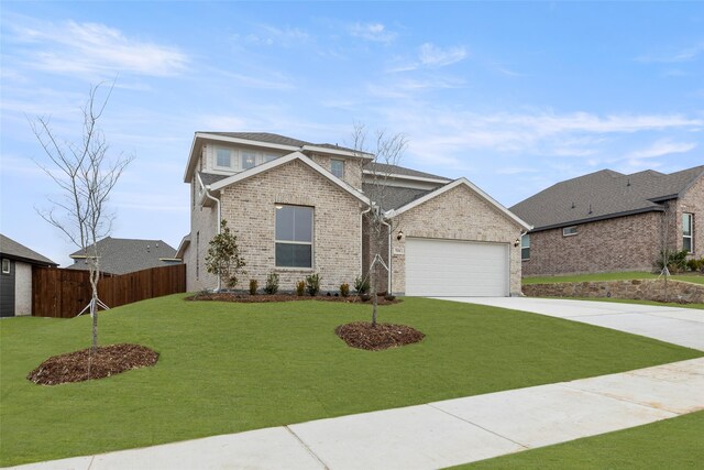 view of front of property featuring a garage and a front yard