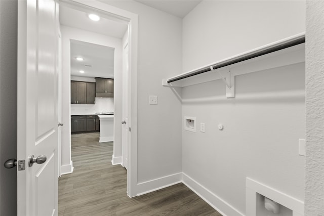 washroom with dark hardwood / wood-style flooring, gas dryer hookup, and hookup for a washing machine