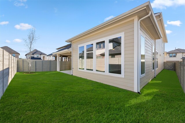 rear view of property with a lawn