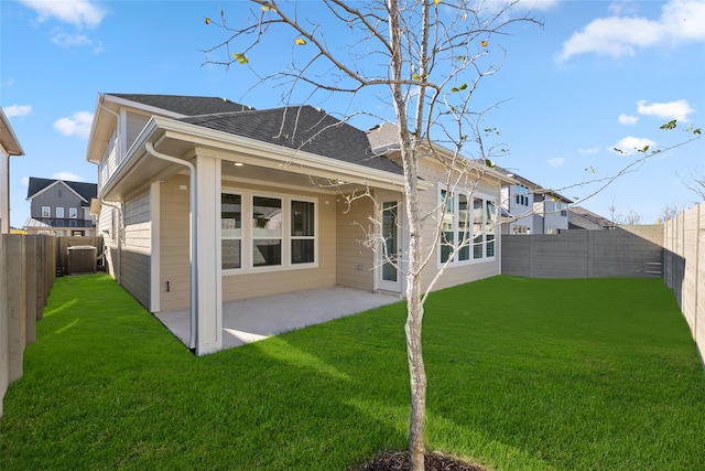 back of house featuring a yard, a patio, and central AC