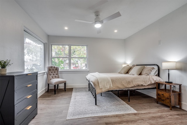 bedroom with light wood-type flooring and ceiling fan