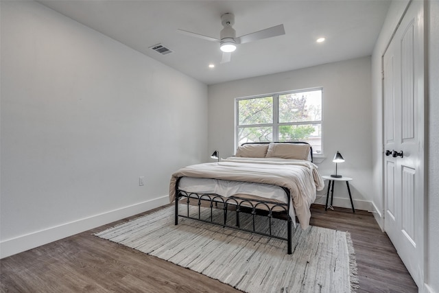 bedroom featuring ceiling fan and dark wood-type flooring