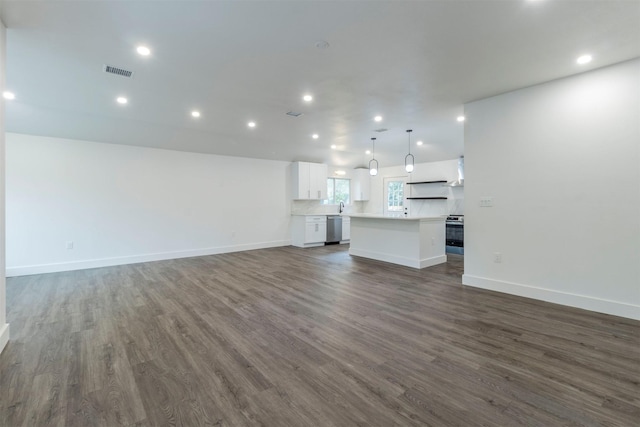 unfurnished living room featuring dark hardwood / wood-style floors