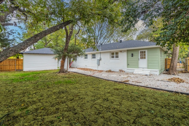 rear view of house with a lawn