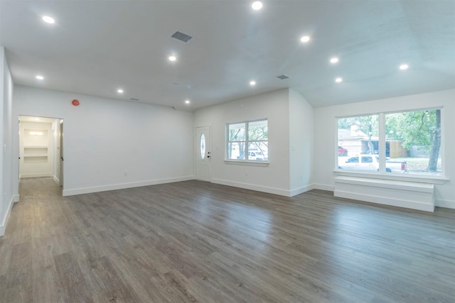 unfurnished room featuring dark hardwood / wood-style floors and a wealth of natural light