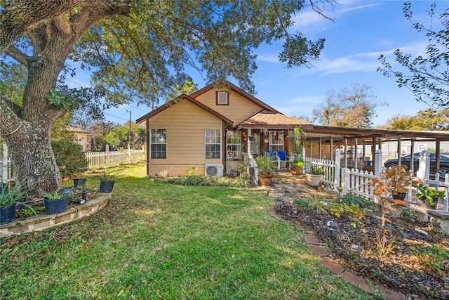 view of front of home with ac unit and a front lawn