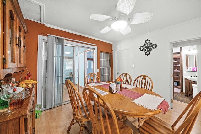 dining area featuring crown molding, light hardwood / wood-style floors, and ceiling fan