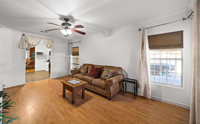 living room featuring ceiling fan, wood-type flooring, and ornamental molding