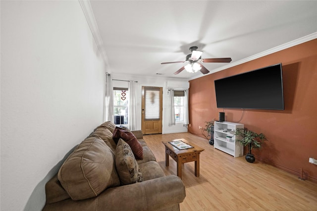 living room with a wall mounted air conditioner, light hardwood / wood-style flooring, ornamental molding, and ceiling fan