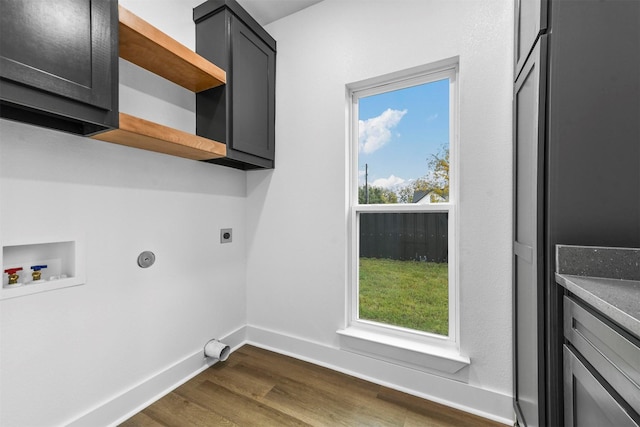 laundry room featuring electric dryer hookup, dark wood-type flooring, a healthy amount of sunlight, and washer hookup