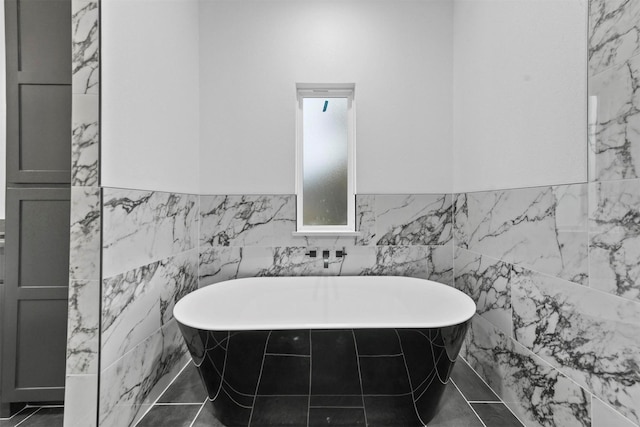 bathroom with tile walls and a tub