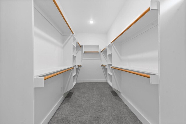 spacious closet featuring dark carpet