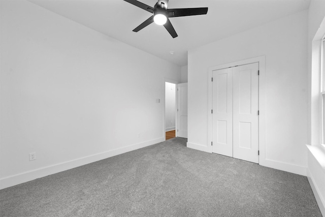 unfurnished bedroom featuring ceiling fan, carpet floors, and a closet