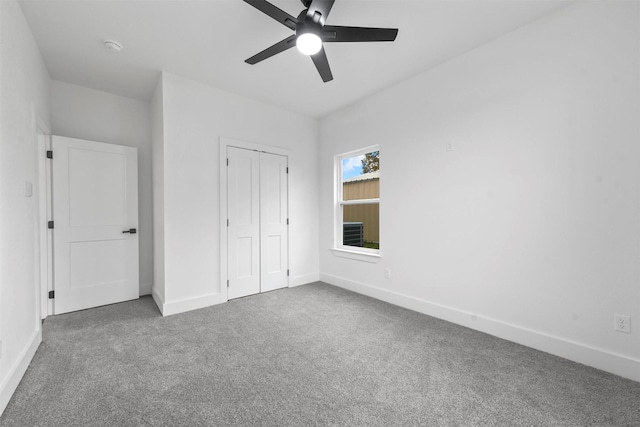 unfurnished bedroom featuring carpet flooring, ceiling fan, and a closet