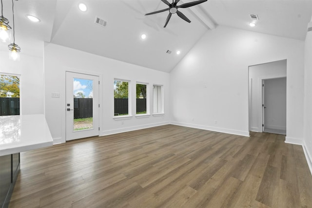 unfurnished living room with beamed ceiling, dark hardwood / wood-style floors, high vaulted ceiling, and ceiling fan