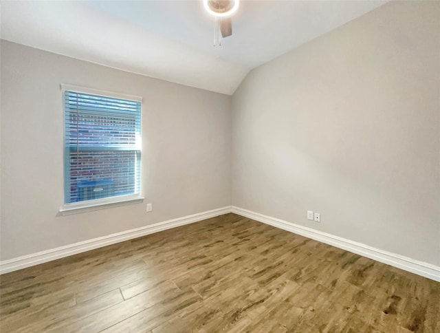 unfurnished room featuring hardwood / wood-style flooring, vaulted ceiling, and ceiling fan