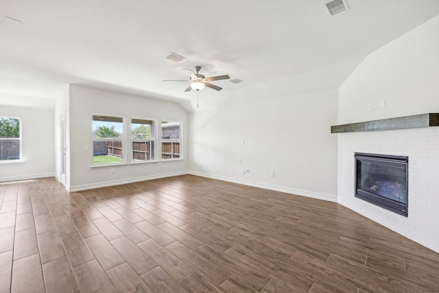 unfurnished living room with plenty of natural light, visible vents, ceiling fan, and dark wood finished floors
