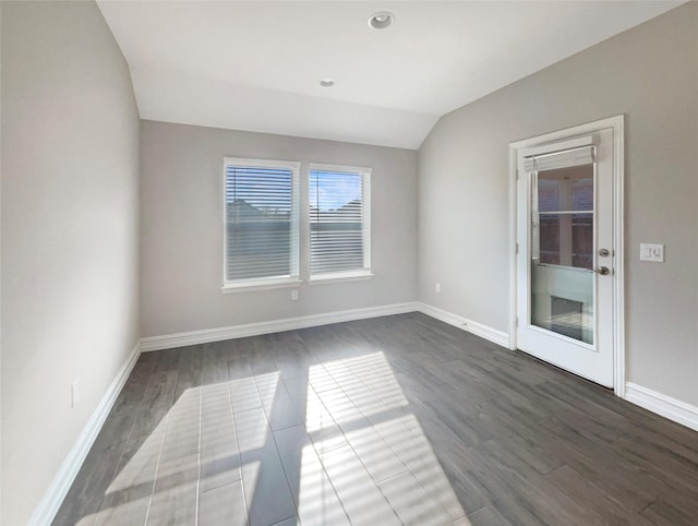 unfurnished room with lofted ceiling and dark hardwood / wood-style floors